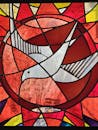 pexels-photo-36689489-36689489 Vibrant stained glass featuring a dove, symbolizing peace and harmony.